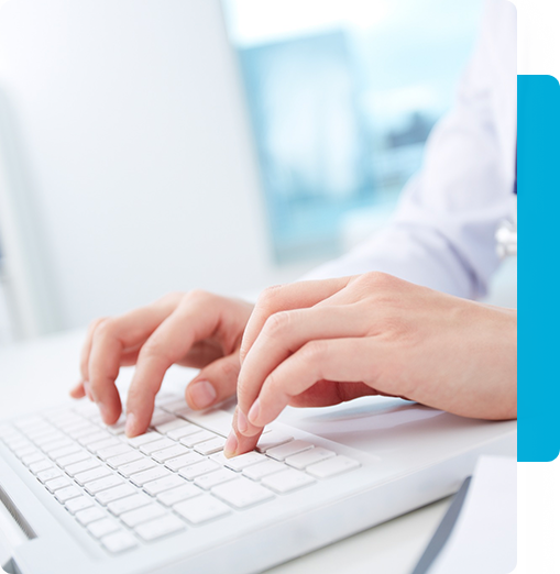 A closeup of hands typing on a laptop