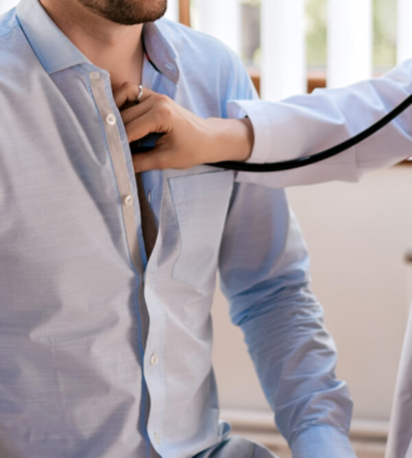 A doctor listening to a patients heart