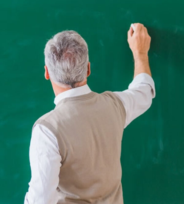 A teacher about to write on a black board