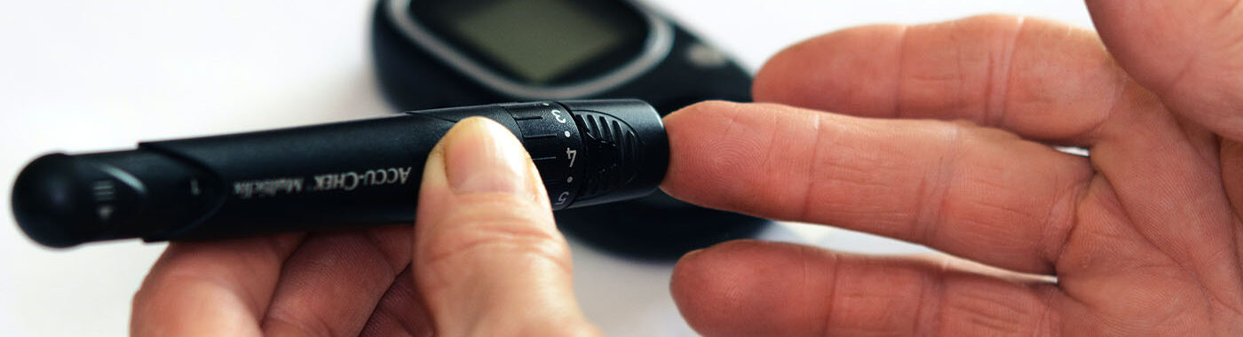 Close up image of someone using blood glucose meter