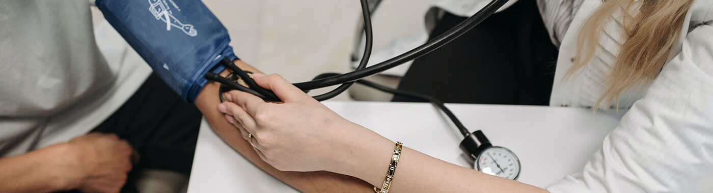 a doctor checking blood pressure - medmark services