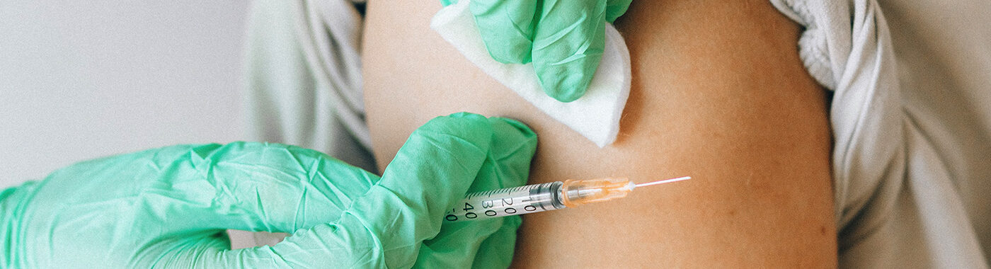 Doctor prepping an arm to give a vaccine, at Medmark health Ireland